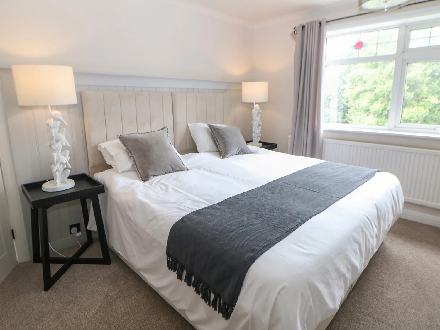 Master bedroom with zip-and-link superking bed and velvet headboard