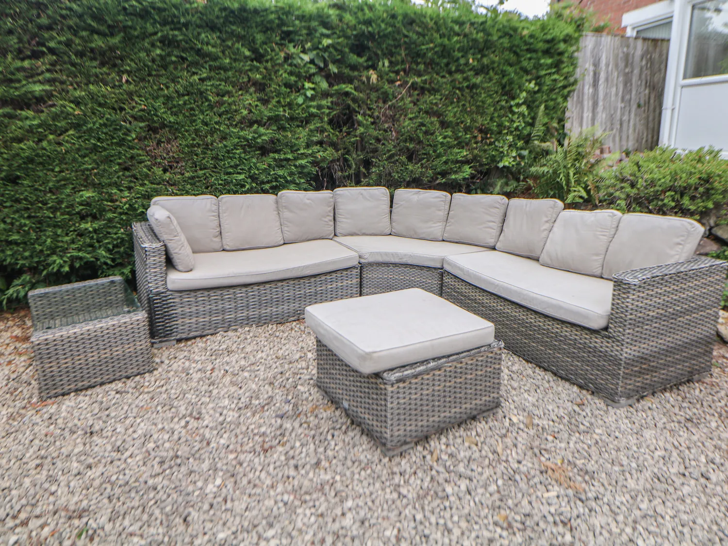 Rattan corner sofa set on the gravel patio in the rear garden