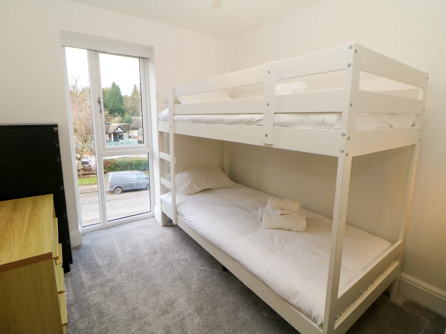 Bunk bedroom with balcony window