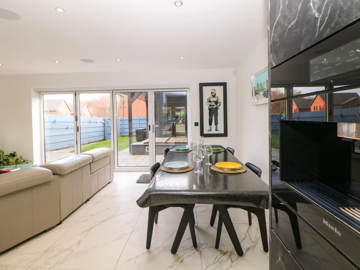 Dining table for six beside bi-fold doors opening to the garden