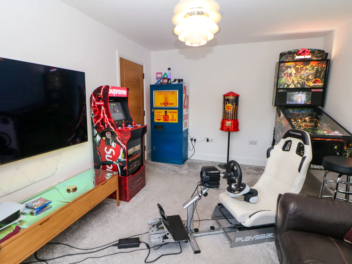 Games room with arcade machine and racing simulator