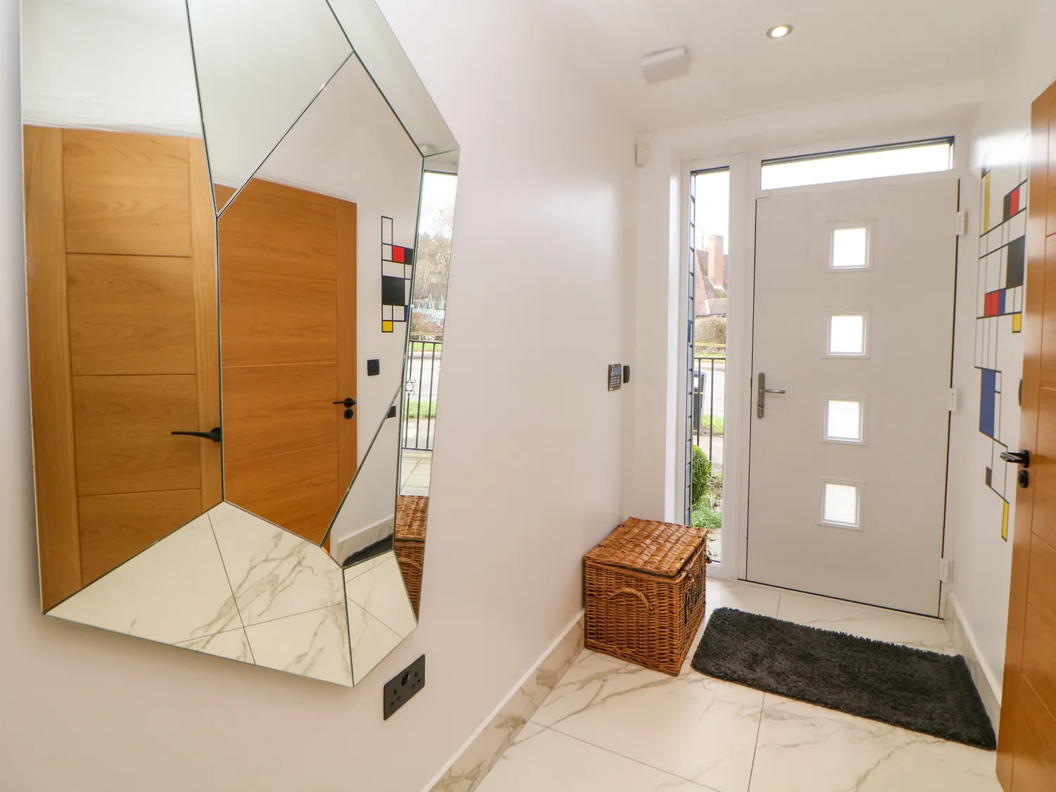Bright entrance hallway with statement mirror and marble floor