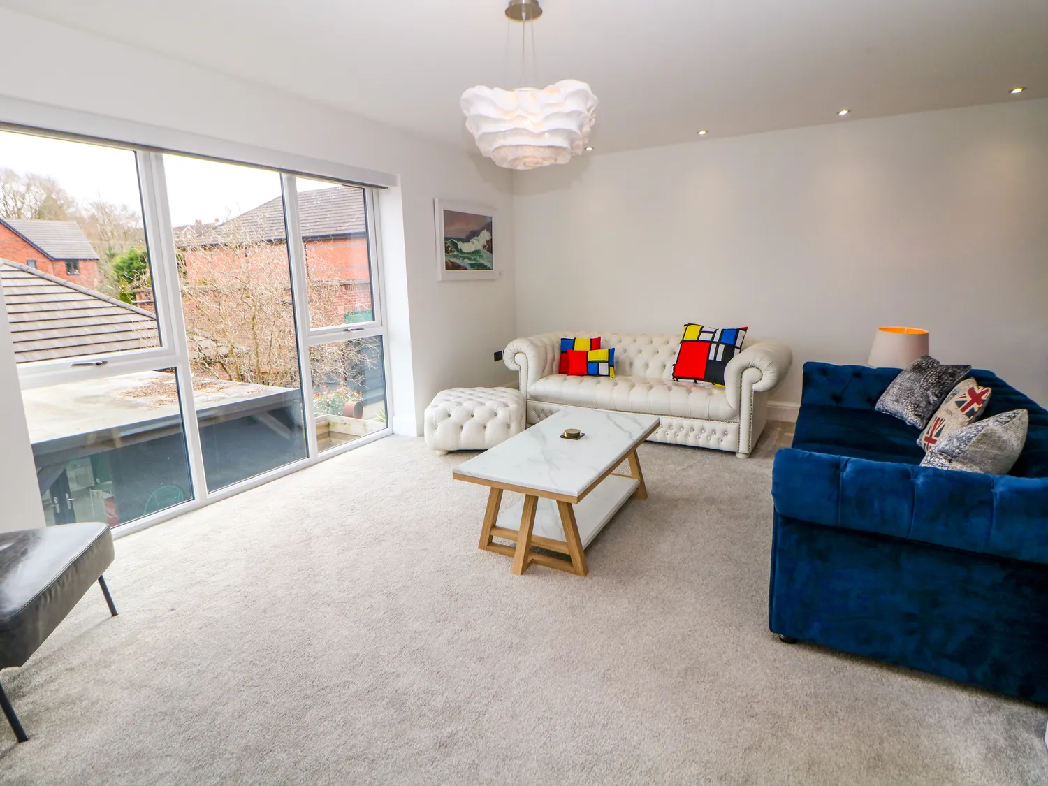 Bright lounge with velvet and chesterfield sofas