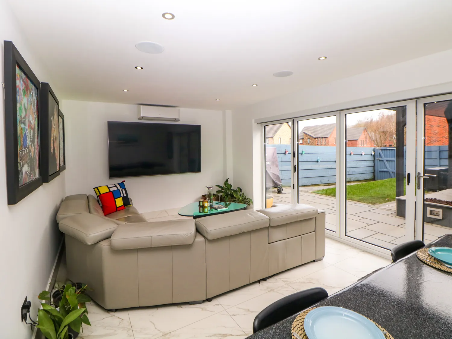 Sitting area with corner sofa and wall-mounted smart TV